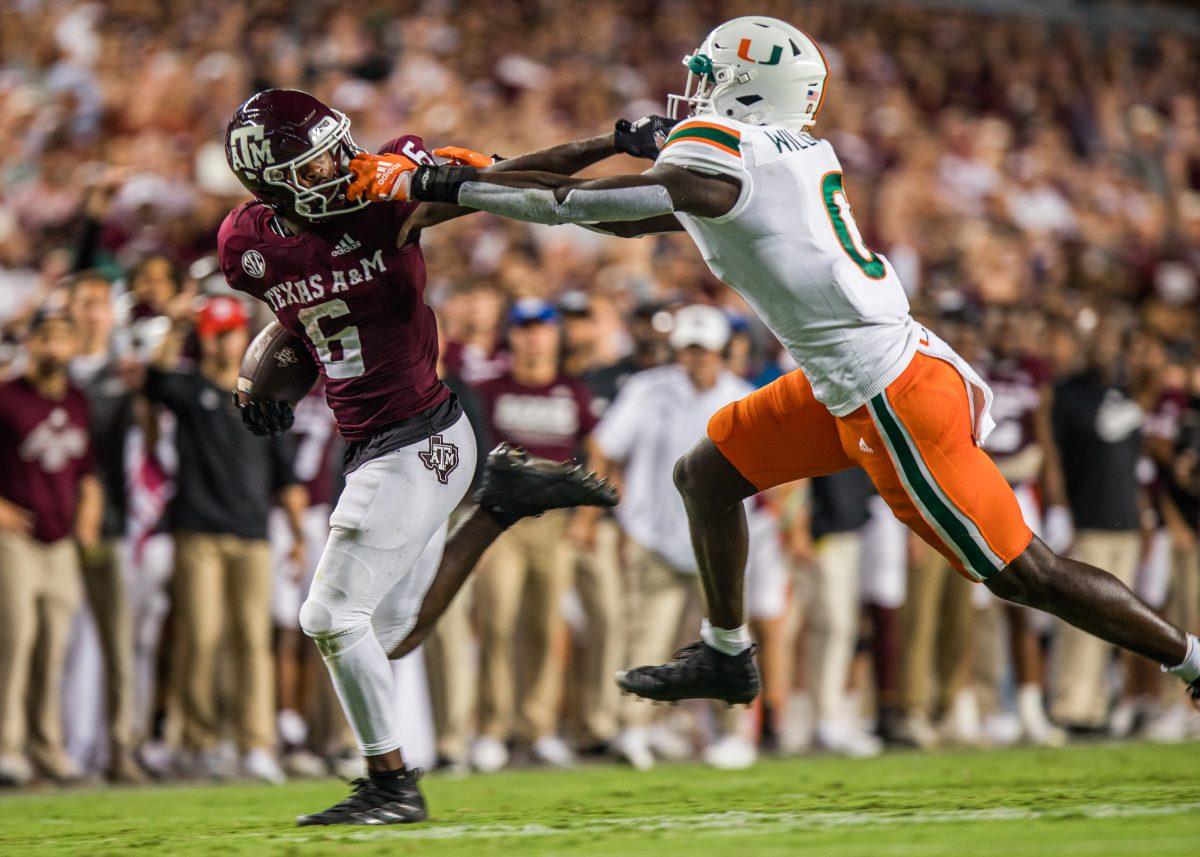 Junior RB Devon Achane (6) stiff arms Miami DB James Williams (0) during Texas A&amp;M's game against Miami at Kyle Field on Saturday, Sept. 18, 2022.