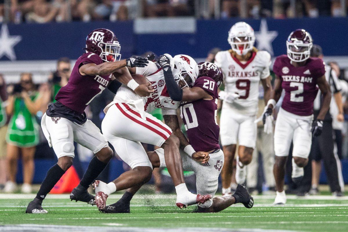 Sophomore DB Tyreek Chappell (7) and sophomore DB Jardin Gilbert (20) tackle Arkansas QB KJ Jefferson (1) during the Southwest Classic on Saturday, Sept. 24, 2022, at AT&T Stadium in Arlington, Texas.