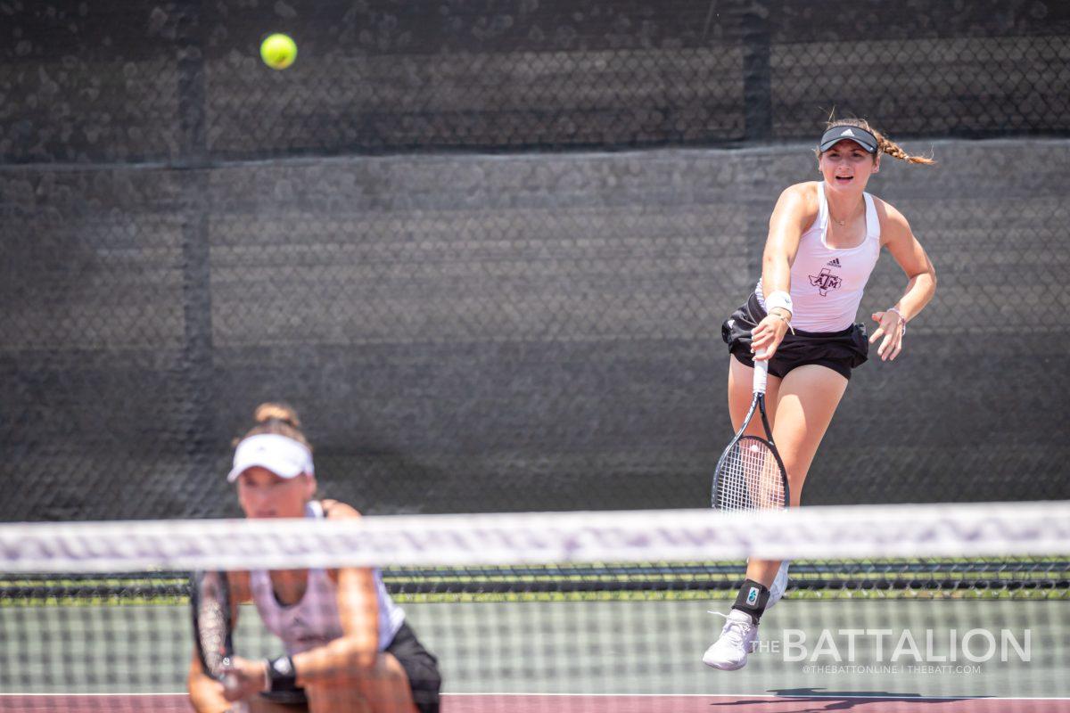 Freshman Mary Stoiana serves the ball during her doubles match with Carson Branstine at the Mitchell Tennis Center on Saturday, May 7, 2022.