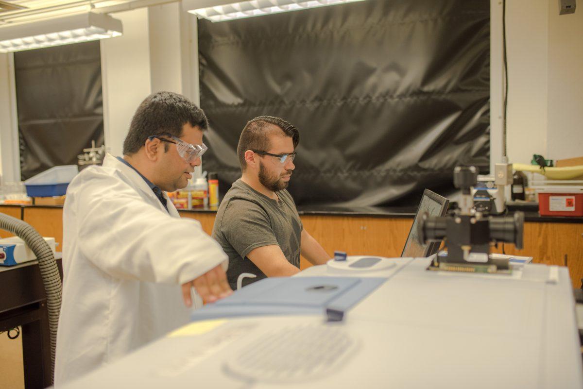 <p>Sarbajit Banerjee, Ph.D., and chemistry Ph.D. student Jaime Ayala work in a lab in the Texas A&M Chemistry Building on Wednesday, Sept. 21, 2022.</p>