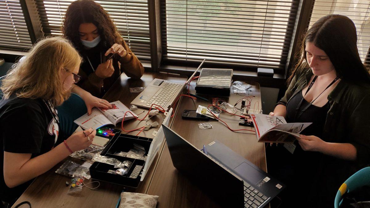 Students work together to build circuit boards at the Aggie STEM Advancing into STEM Camp.