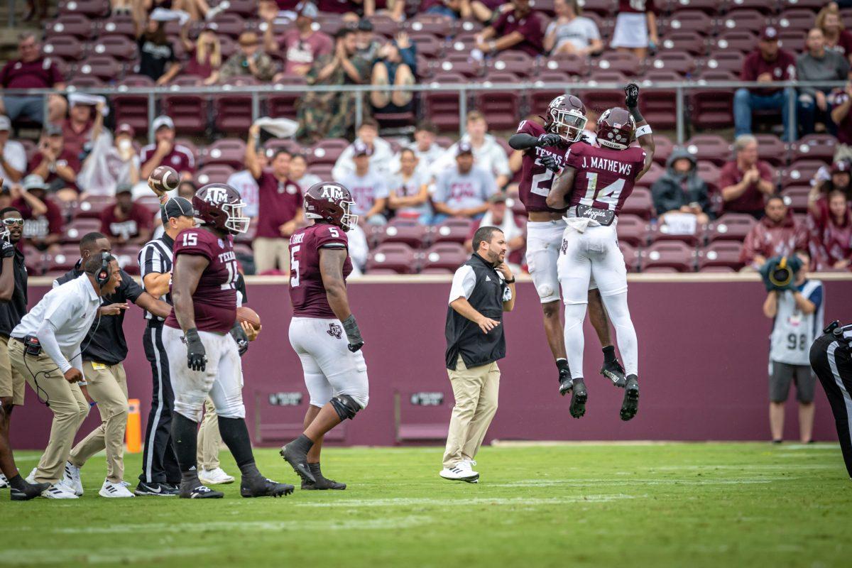 Freshman DB Jacoby Mathews (14) celebrates with a teammate after recovering a Sam Houston State fumble during the Aggies' game against Sam Houston State at Kyle Field on Saturday, Sept. 3, 2022.