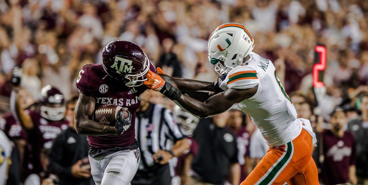 Junior RB Devon Achane (6) attempts to stiff arm Miami DB James Williams (0) as Williams grabs onto Achanes face mask during Texas A&Ms game against Miami at Kyle Field on Saturday, Sept. 17, 2022.