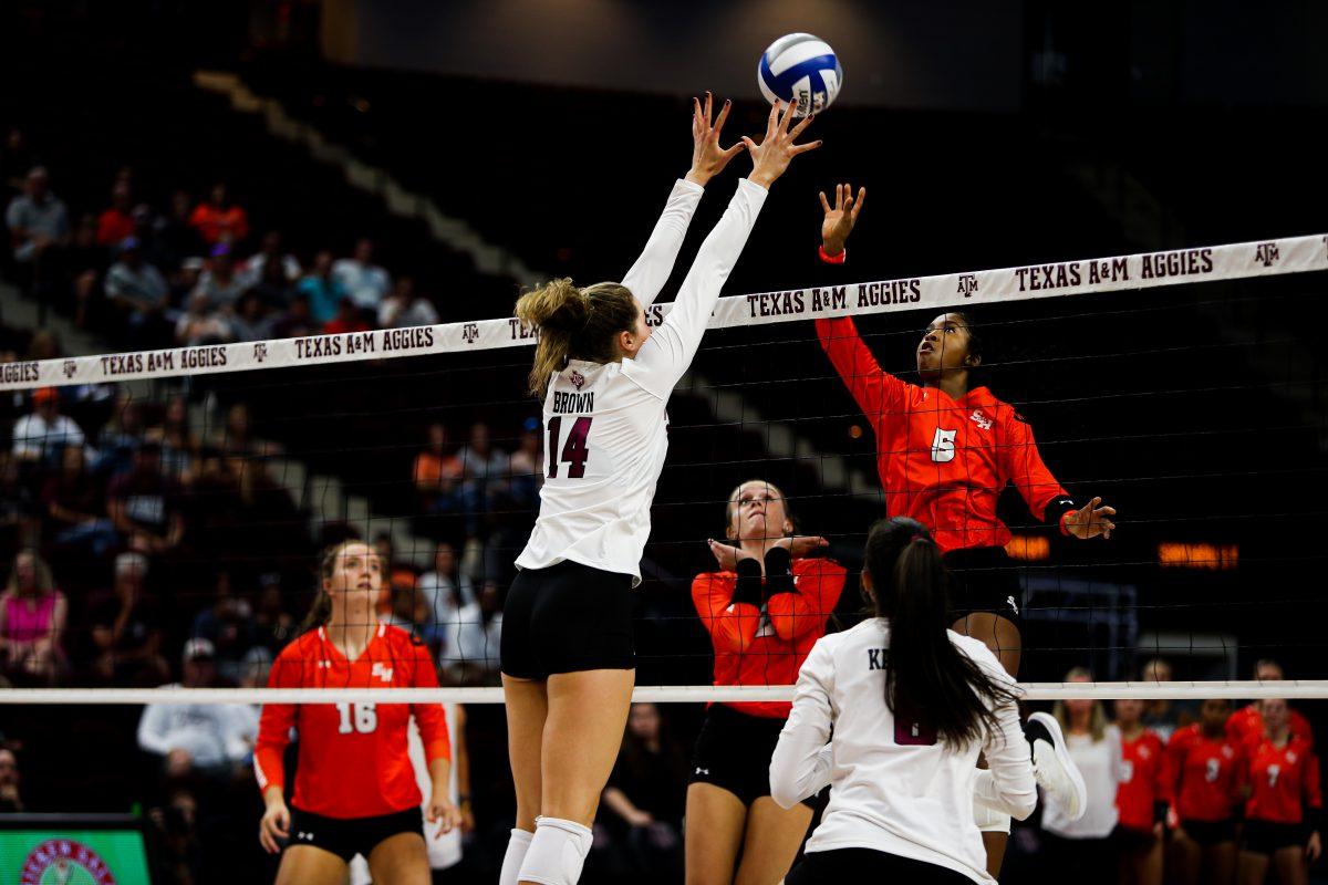 Molly Brown (14) blocks Sam Houstons ball at Reed Arena on Tuesday, Sept. 6, 2022.