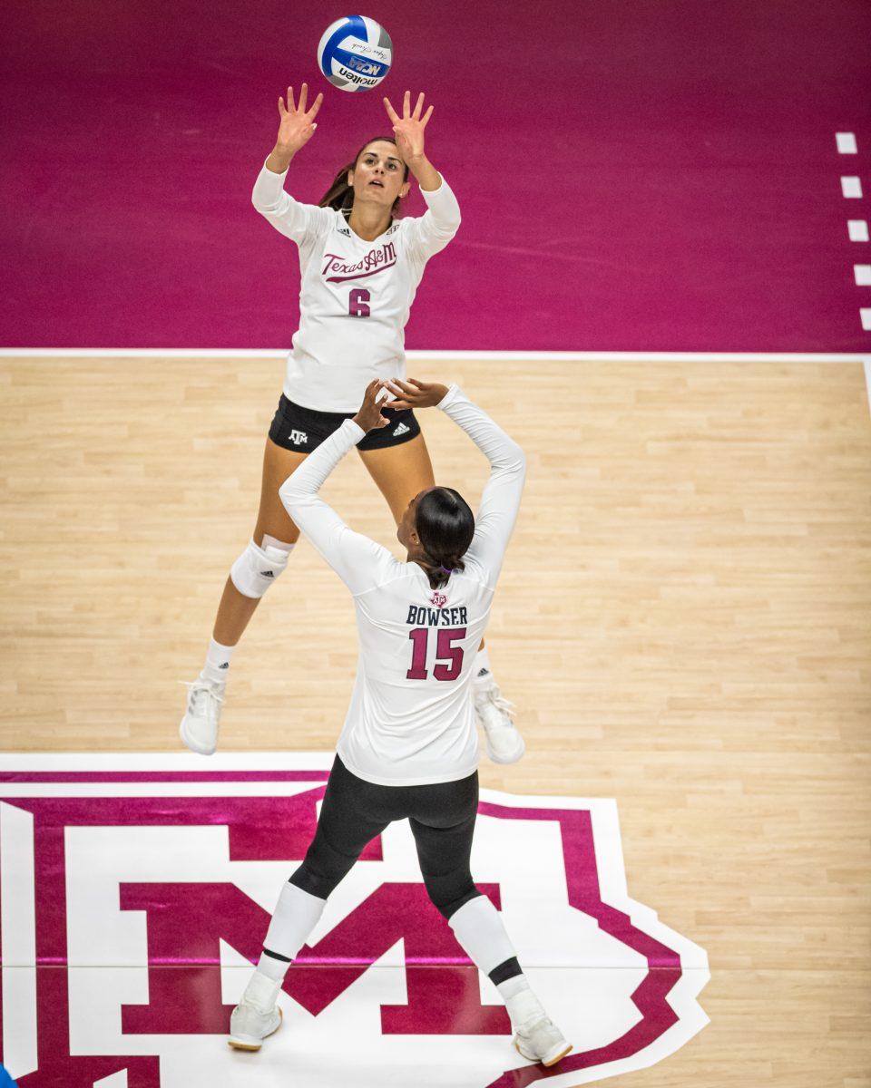 Graduate S Elena Karakasi (6) sets up a spike for redshirt junior MB Madison Bowser (15) during the Aggies match against San Diego on Saturday, Aug. 27, 2022 at Reed Arena.