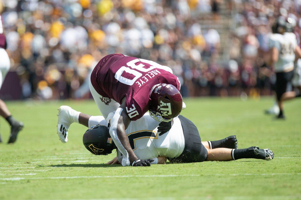 Redshirt freshman DL Tunmise Adeleye (30) tackles App States Chase Brice( 7) at Kyle Field on Saturday, Sep. 10, 2022.