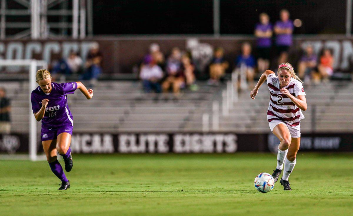 With the TCU player catching up to her, junior middle fielder Kate Colvin (2) pushes up towards the goal at Ellis Field on Thursday, Sept. 8, 2022.