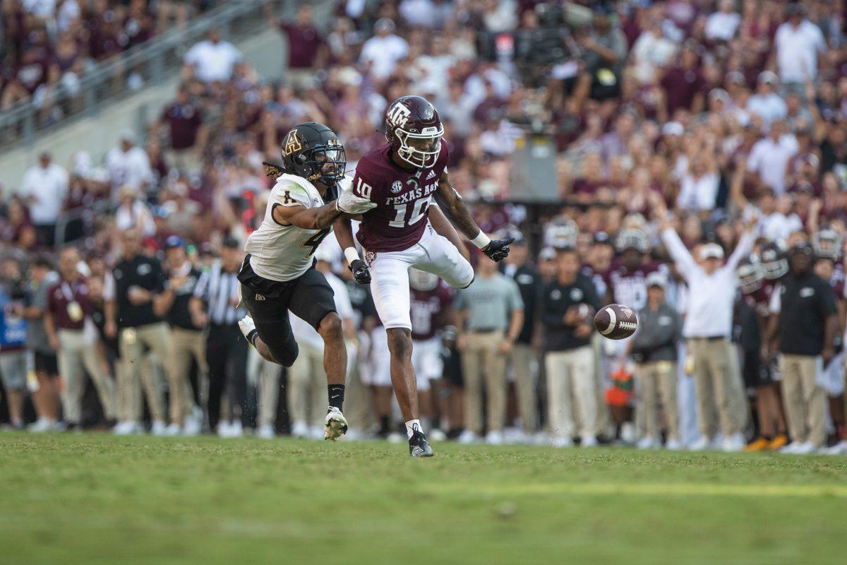App States Nick Ross (4) grabs freshman WR Chris Marshall (10) at Kyle Field on Saturday, Sep. 10, 2022.