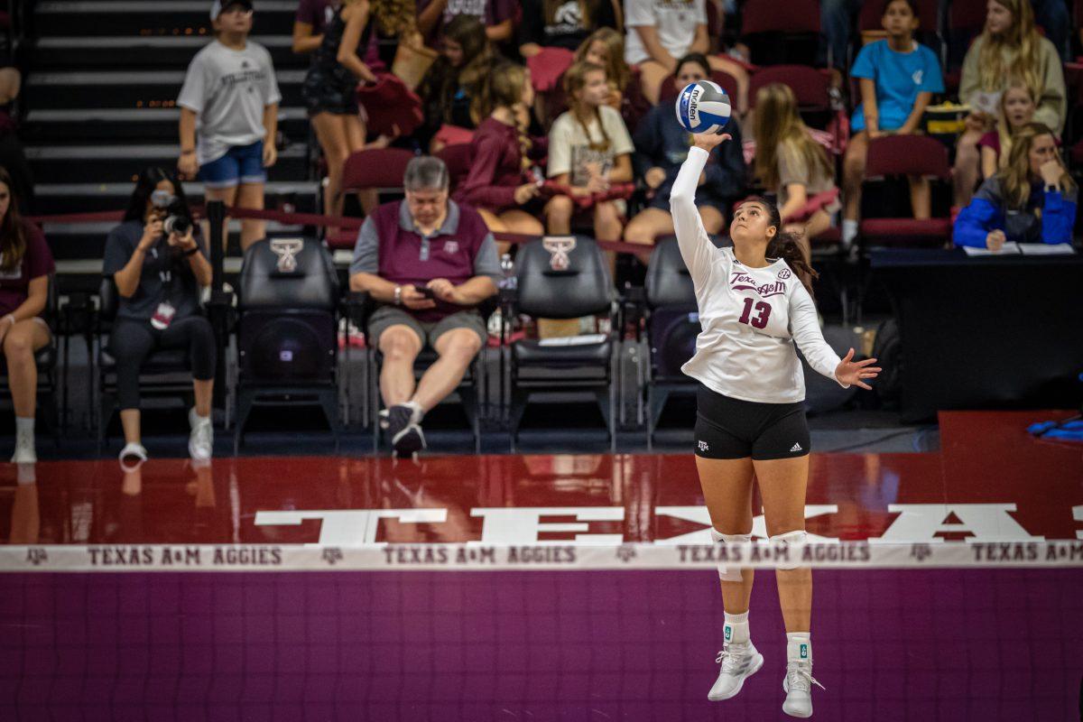 Sophomore Nisa Buzlutepe (13) serves the ball during the Aggies match against San Diego on Saturday, Aug. 27, 2022 at Reed Arena.