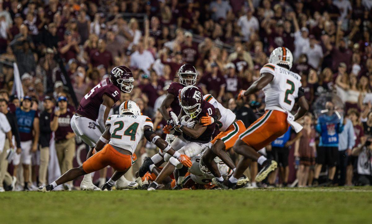 Senior WR Ainias Smith (0) is stopped by the Miami defense at Kyle Field on Saturday, Sept. 17, 2022.