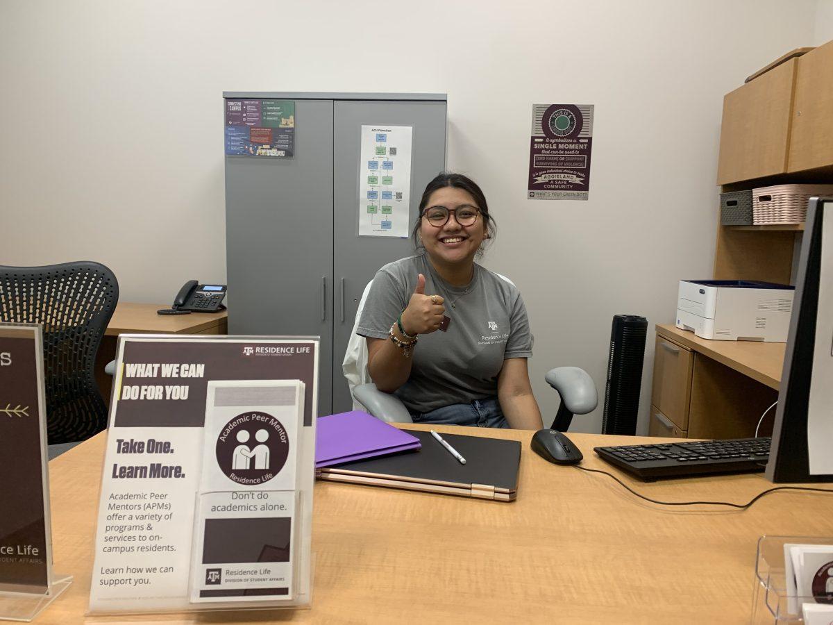 Laura Gonzalez giving the Gig Em while attending her office hours in the Commons office (Commons 102).