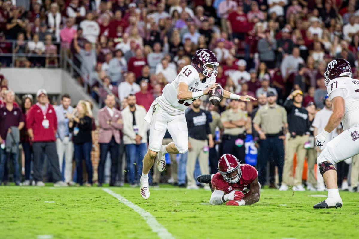 Sophomore QB Haynes King (13) slips away from Alabama DB Will Anderson Jr. (31) during a game against the Alabama Crimson Tide on Saturday, Oct. 8, 2022, at Bryant-Denny Stadium in Tuscaloosa, Alabama.