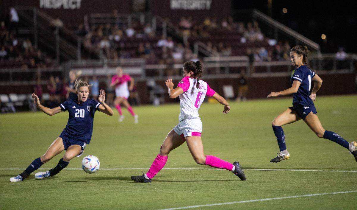 <p>Rice D Carsyn Martz (20) blocks the shot of sophomore F Maile Haynes (8) during Texas A&M's match against Rice at Ellis Field on Sunday, Oct. 2, 2022.</p>