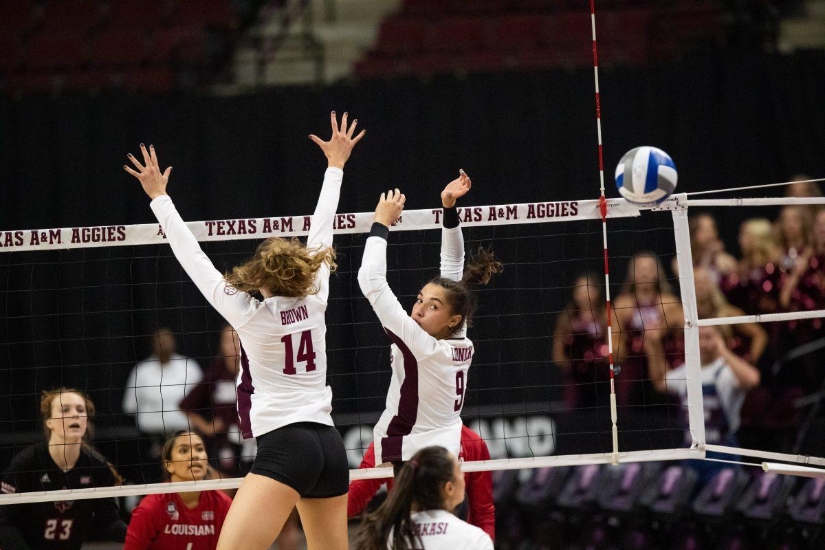 Junior MB Molly Brown (14) and freshman OPP Logan Lednicky jump and miss the ball at Reed Arena on Friday, Sep. 2, 2022.