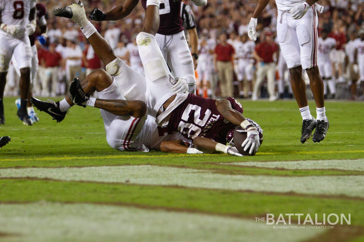 Running back Isaiah Spiller scoring a touchdown.