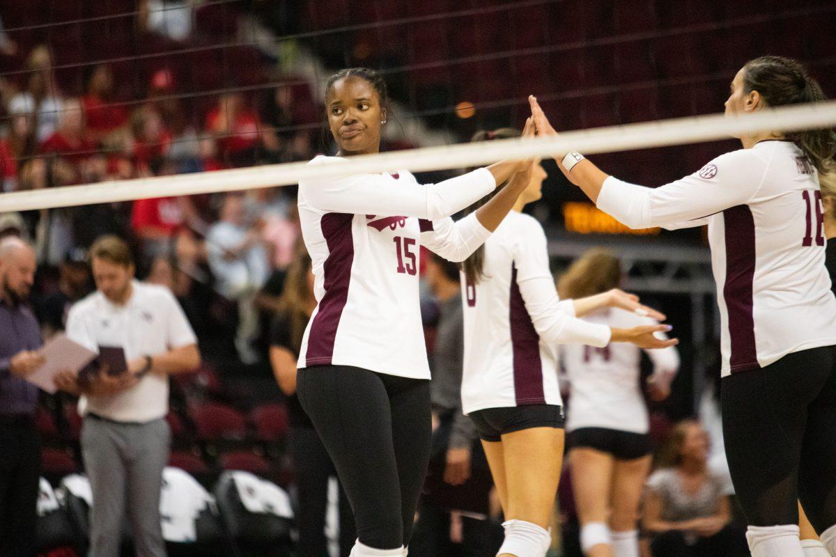 Redshirt junior MB Madison Bowser (15) and graduate student Caroline Meuth (16) celebrate a point at Reed Arena on Friday, Sep. 2, 2022.