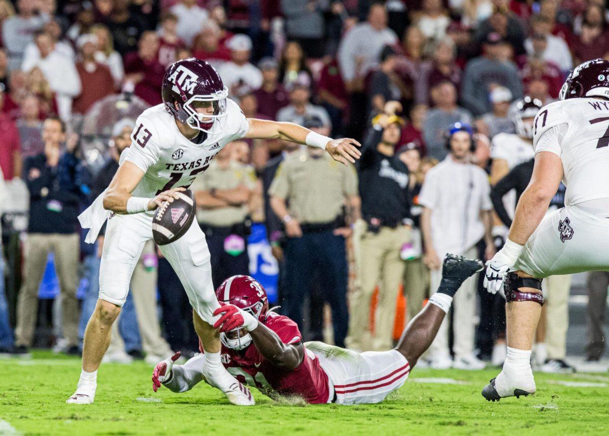 Sophomore QB Haynes King (13) slips away from Alabama DB Will Anderson Jr. (31) during a game against the Alabama Crimson Tide on Saturday, Oct. 8, 2022, at Bryant-Denny Stadium in Tuscaloosa, Alabama.