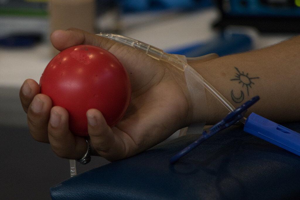 A blood donor holds a stress ball during a donation on June 28, 2021. 