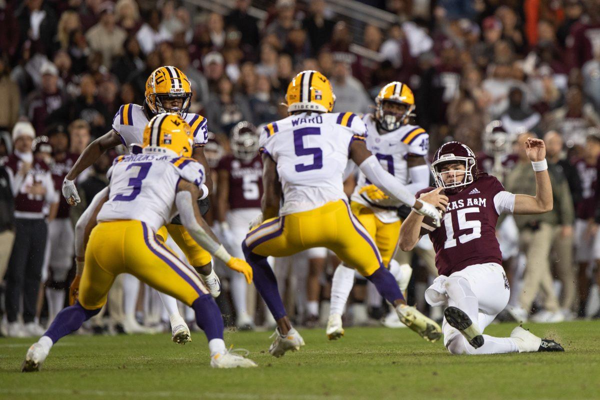 Freshman QB Conner Weigman (15) slides toward LSU defensive line during A&Ms game against LSU at Kyle Field on Saturday, Nov. 26, 2022. (Cameron Johnson/The Battalion)