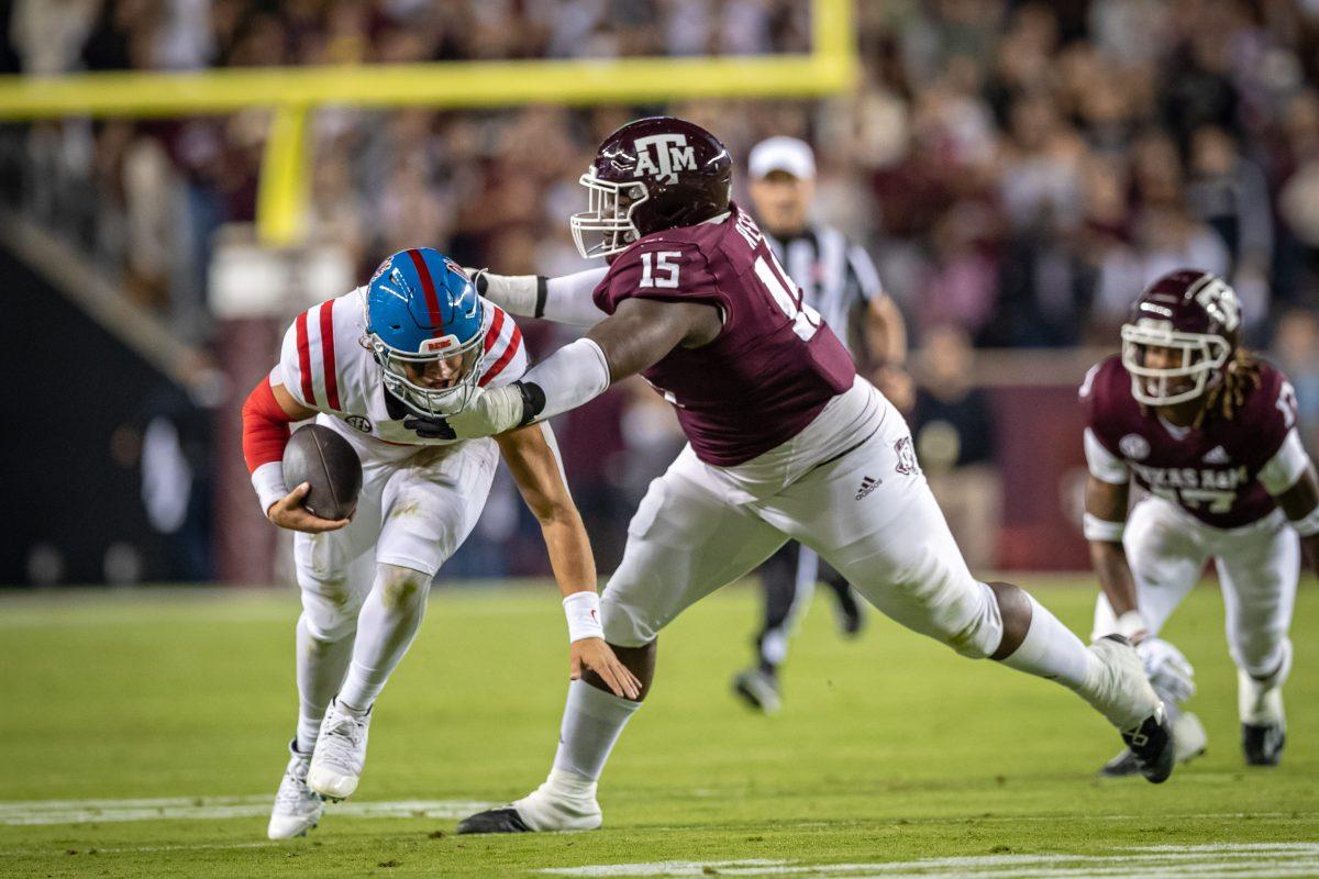 Freshman DL Albert Regis (15) tackles Ole Miss QB Jaxson Dart (2) during Texas A&Ms game against Ole Miss at Kyle Field on Saturday, Oct. 29, 2022.