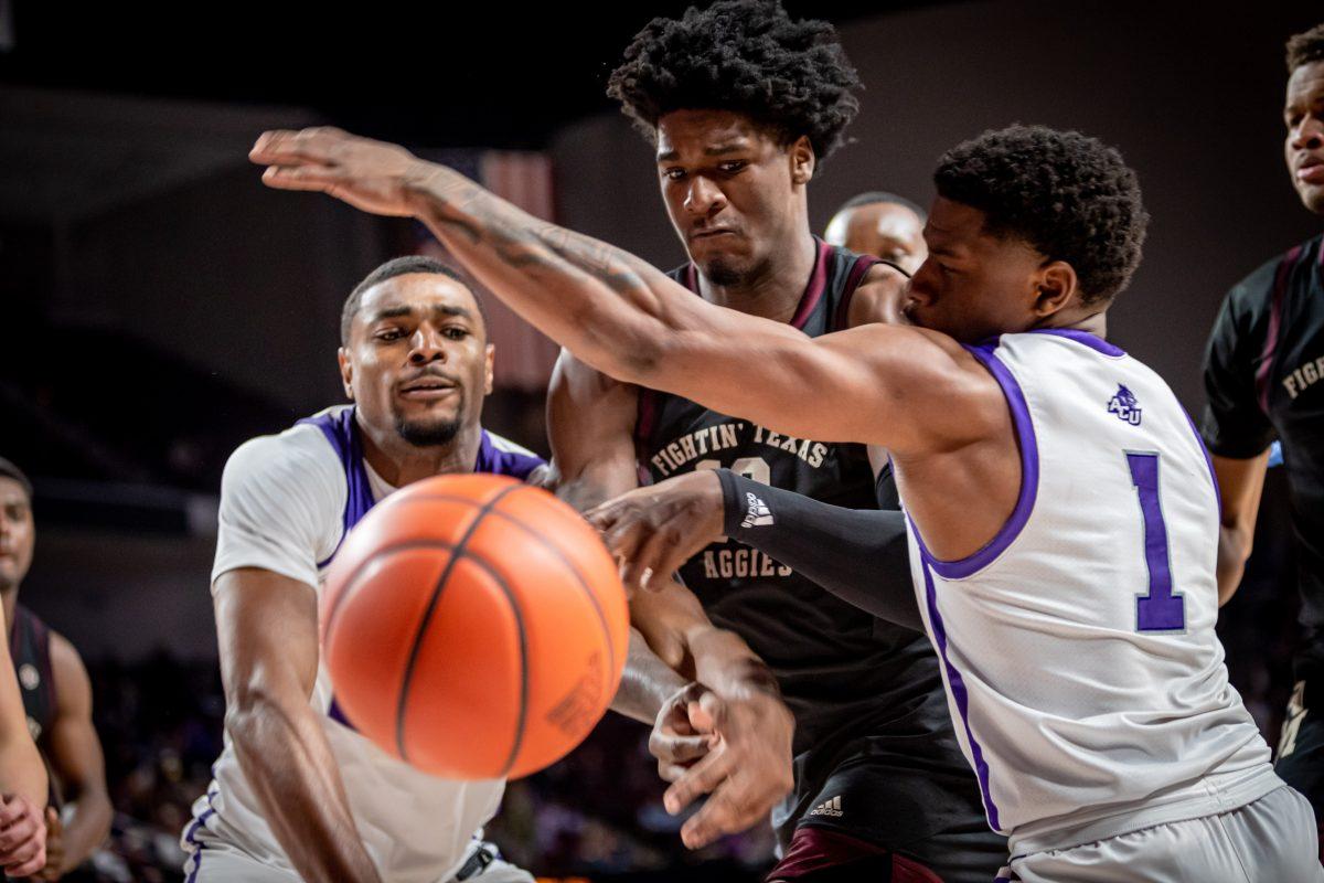 Freshman F Solomon Washington (13) has the ball knocked away from him while under double coverage during Texas A&Ms game against ACU at Reed Arena on Friday, Nov. 11, 2022.