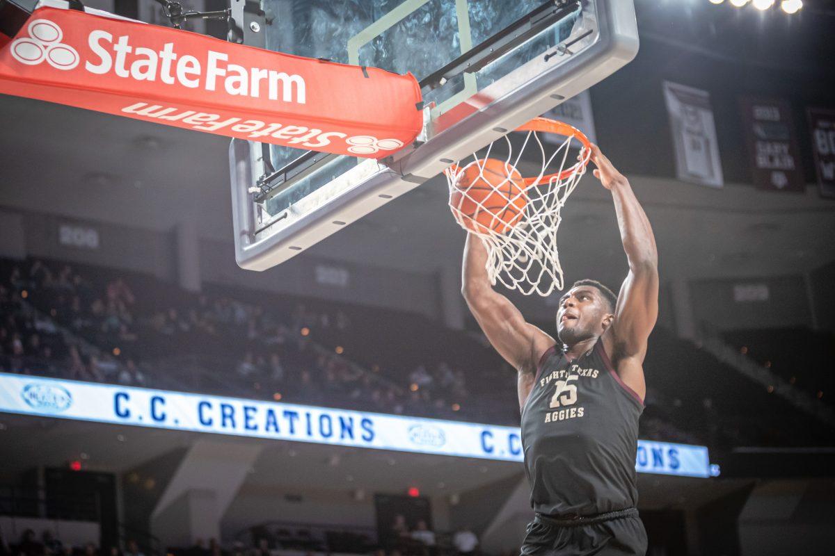 Junior F Henry Coleman III (15) dunks on the ACU basket after forcing a turnover during Texas A&amp;M's game against ACU at Reed Arena on Friday, Nov. 11, 2022.