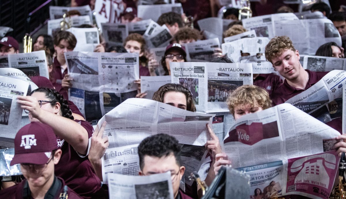 Members of the Hullabaloo Band read the Nov. 3, 2022 edition of The Battalion during A&Ms game against A&M Kingsville at Reed Arena on Friday, Nov. 4, 2022. (Cameron Johnson/The Battalion)