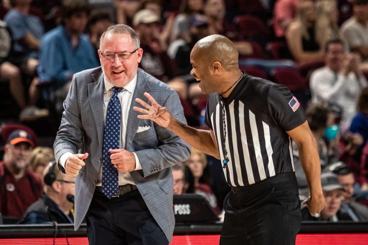Texas A&M coach Buzz Williams jokes with official Wesley Ford after a foul was called on ULM during Texas A&Ms game against ULM at Reed Arena on Monday, Nov. 7, 2022.