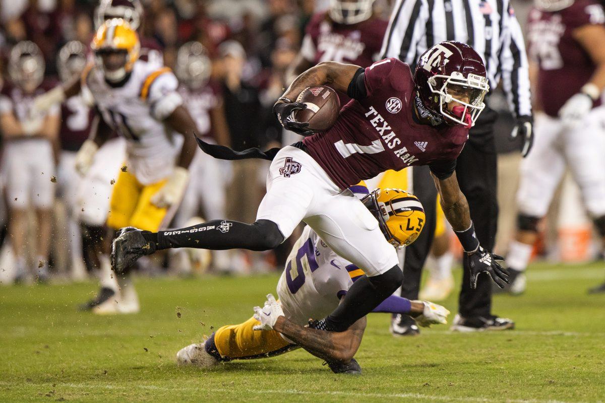 Freshman WR Evan Stewart (1) gets tackled by LSU Jay Ward (5) during A&Ms game against LSU at Kyle Field on Saturday, Nov. 26, 2022. (Cameron Johnson/The Battalion)