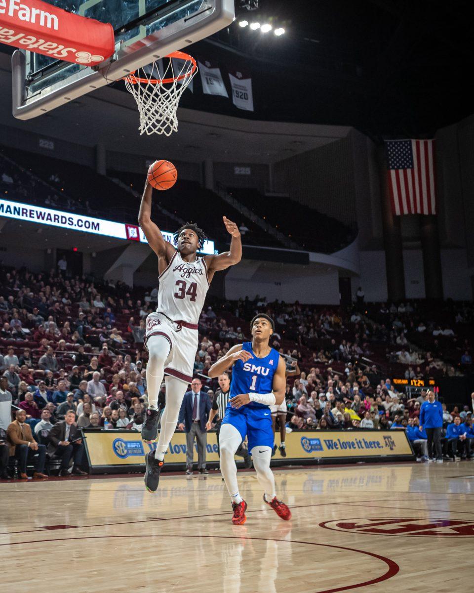 <p>Junior F Julius Marble (34) jumps to dunk during Texas A&M's game against SMU at Reed Arena on Wednesday, Nov. 30, 2022.</p>