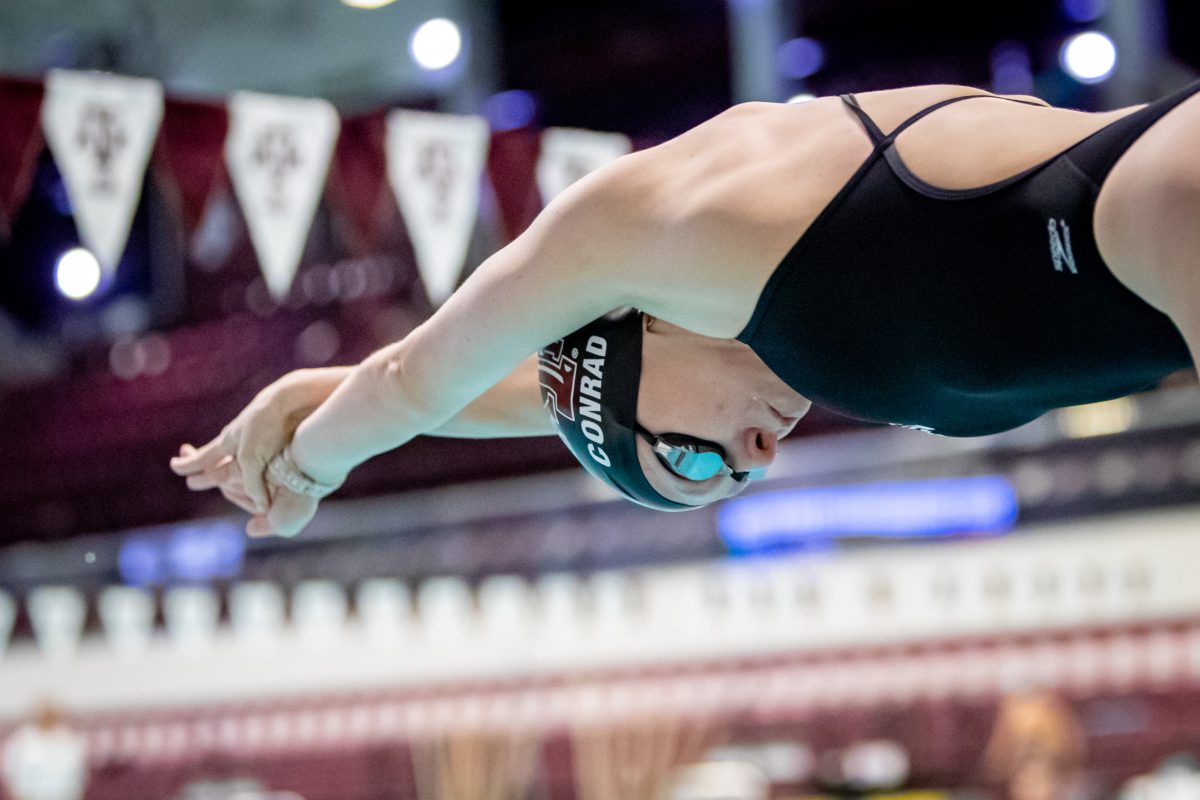 Senior Ashley Conrad dives from the starting block in the 200 yard freestyle during Texas A&Ms meet against Rice at the Rec Center Natatorium on Saturday, Dec. 3, 2022.