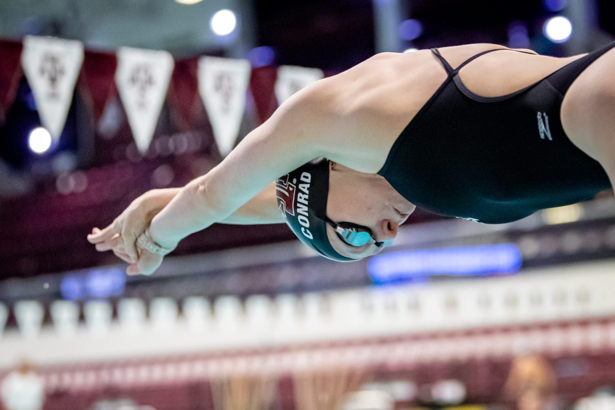 Senior Ashley Conrad dives from the starting block in the 200 yard freestyle during Texas A&amp;M's meet against Rice at the Rec Center Natatorium on Saturday, Dec. 3, 2022.