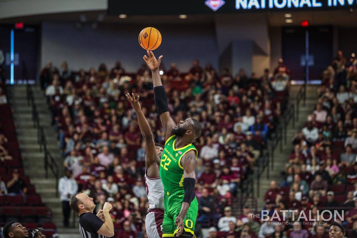 Sophomore forward Henry Coleman III (15) and Franck Kepnang (22) go for the ball during tipoff in Reed Arena during the Aggies game against the Ducks on Saturday, Mar. 19, 2022.