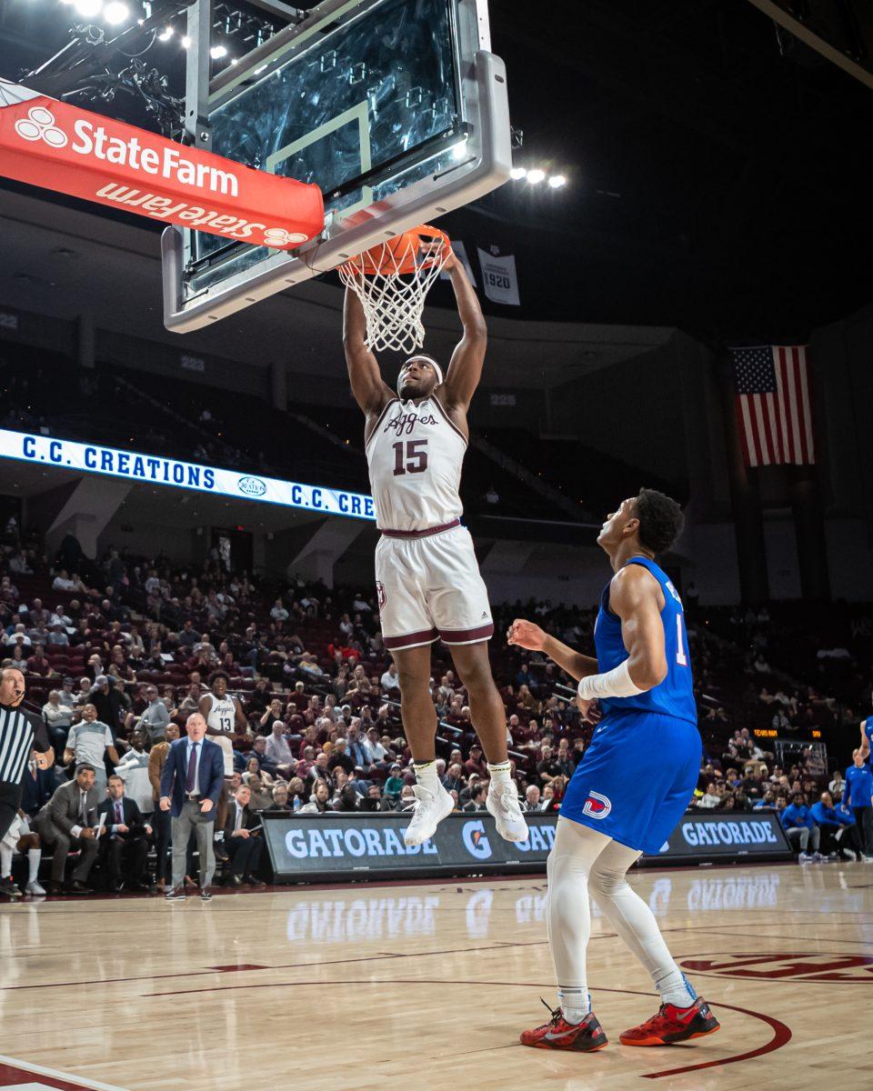 Junior F Henry Coleman III (15) jumps to dunk on SMU during Texas A&amp;M's game against SMU at Reed Arena on Wednesday, Nov. 30, 2022.