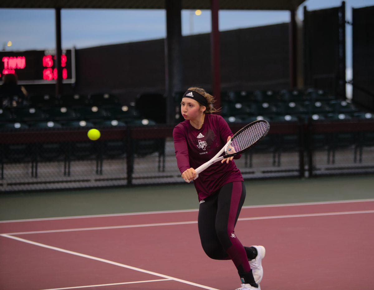 <p>Sophomore Mary Stoiana rushing to return a short volley at Mitchell Outdoor Tennis Center on Friday, Jan. 20, 2023.</p>