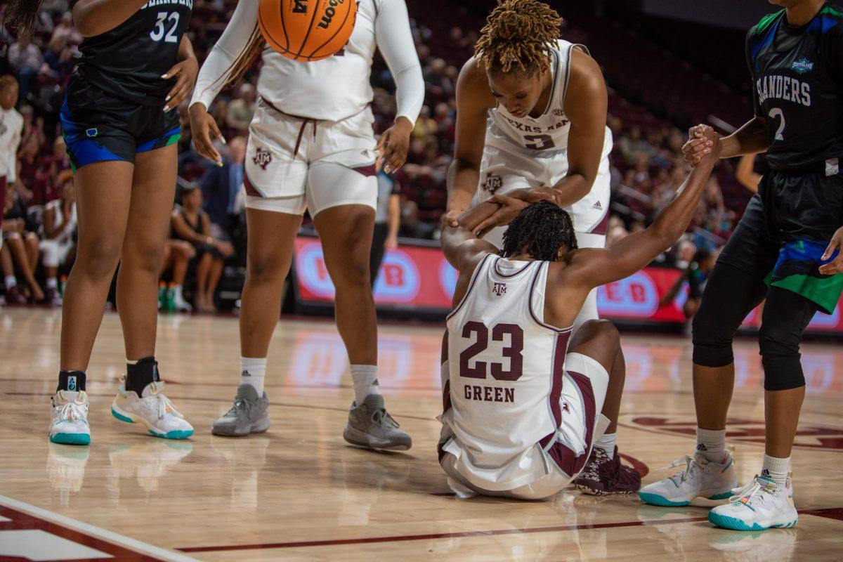 Freshman F Janiah Barker (2) helps up Graduate G McKinzie Green (23) after a foul during A&Ms game against Texas A&M-Corpus Christi at Reed Arena on Thursday, Nov. 10, 2022.