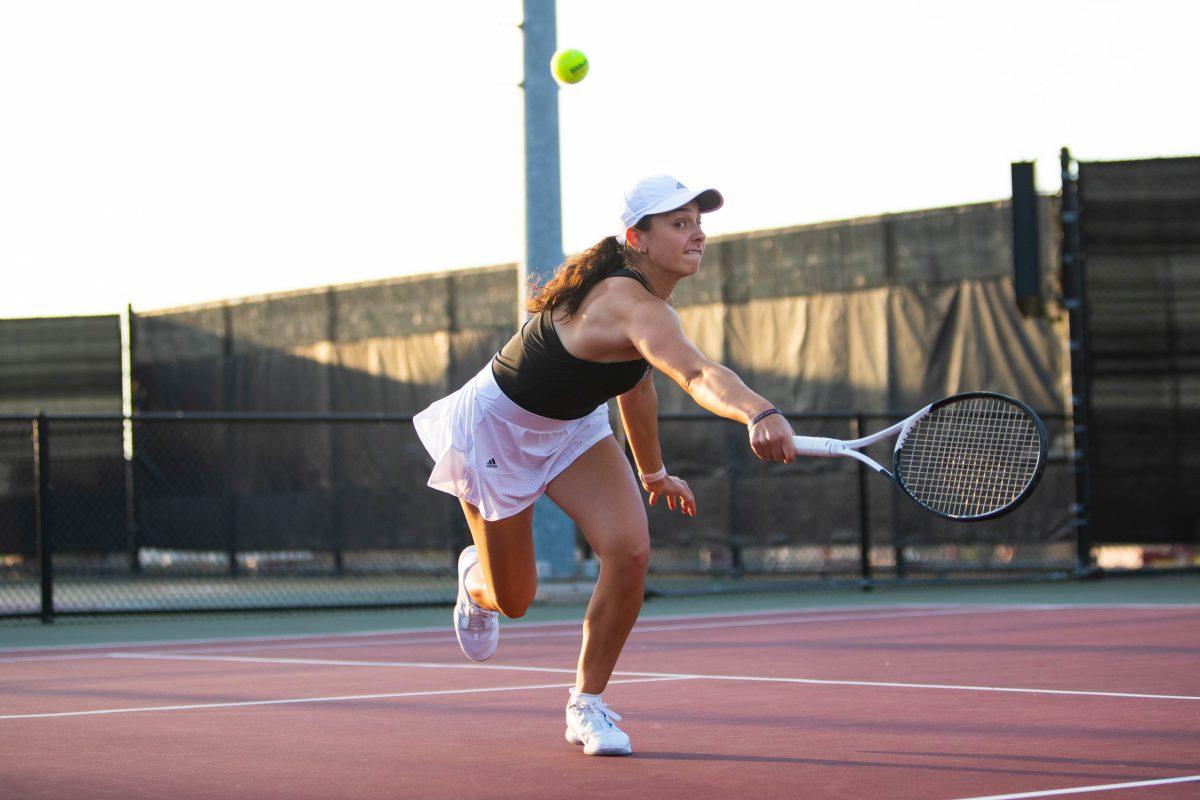Freshman Mia Kurpes being able to make contact with the tennis ball with a volley move at Mitchell Outdoor Tennis Center on Tuesday, Jan. 17, 2023.