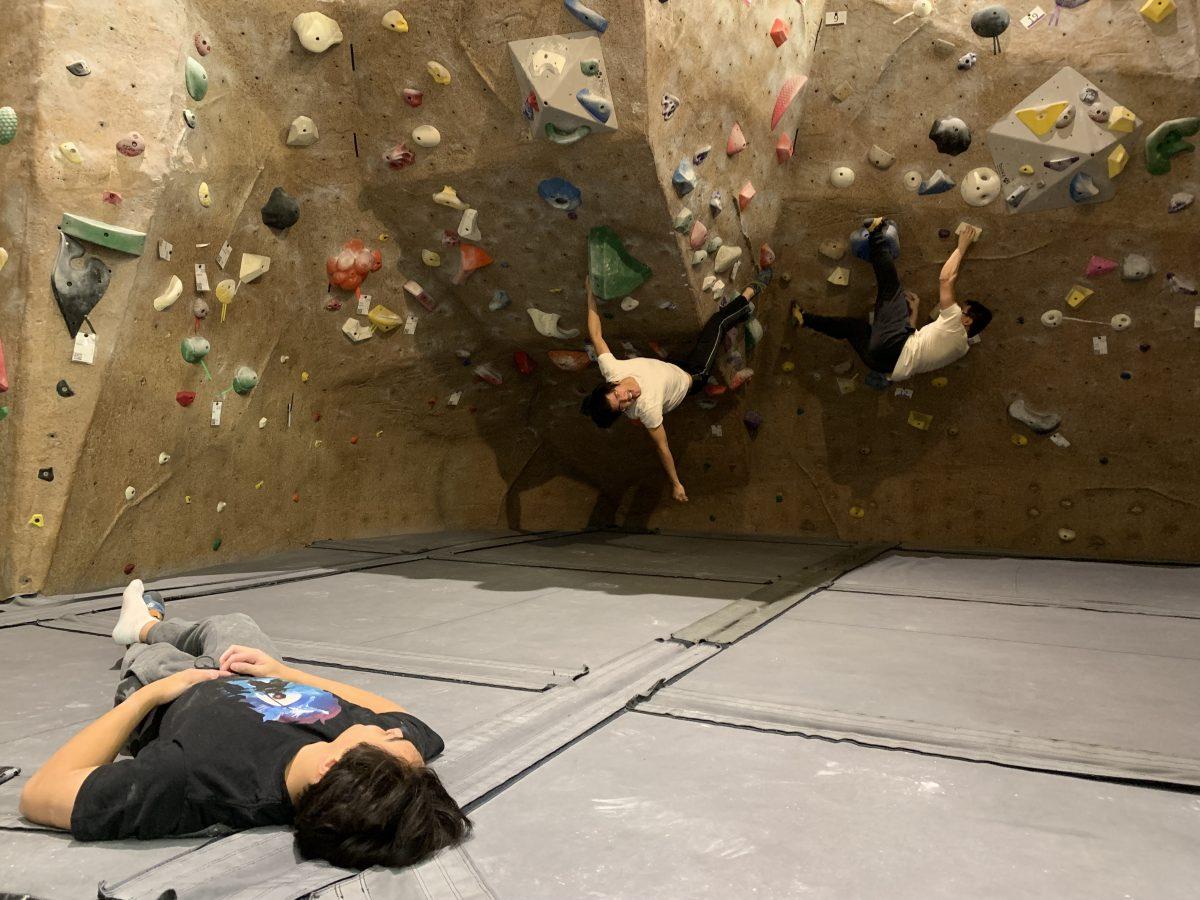 <p>Business major Christopher Guzman '25, Electrical engineering major Albert Nguyen '25 and Physics major Cory Ho '25 climb rocks at the Student Rec Center</p>