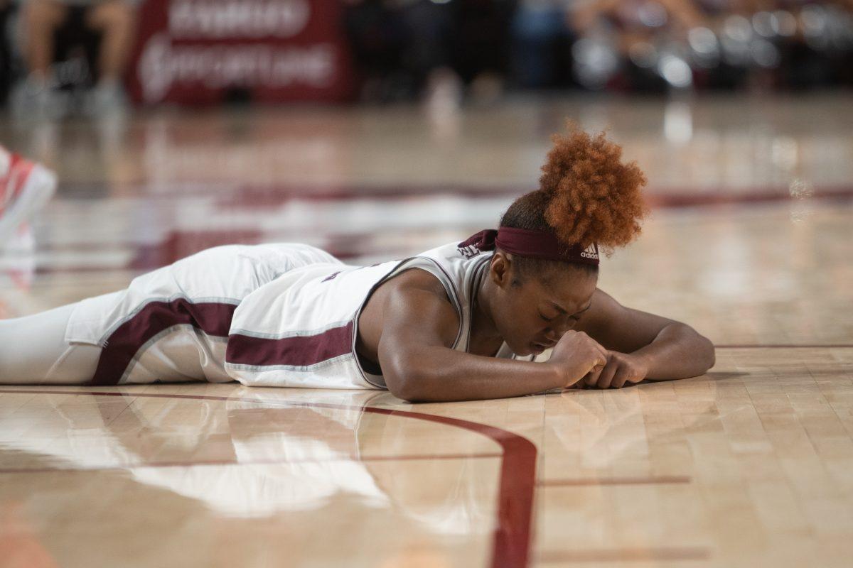 Junior G Kay Kay Green (4) gathers herself on the ground during A&Ms game at Reed Arena on Sunday, Jan. 22, 2022.