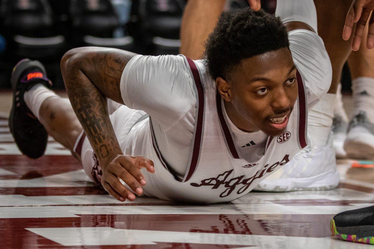 Sophomore G Wade Taylor IV (4) is helped up after falling during Texas A&Ms game against SMU at Reed Arena on Wednesday, Nov. 30, 2022.