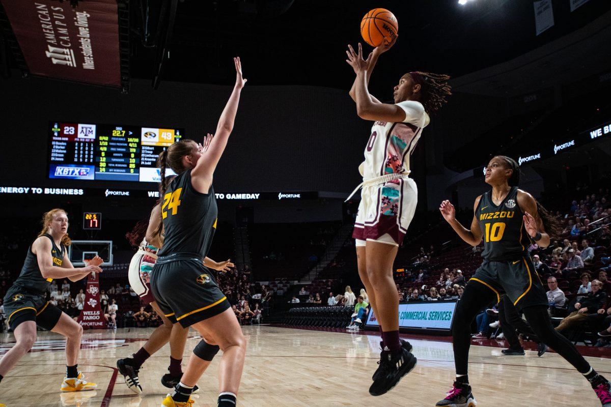 Freshman G Sydney Bowles (00) pulls up with a floater in front of Freshman G Ashton Judd (24) at Reed Arena on Monday, Feb. 20, 2023.