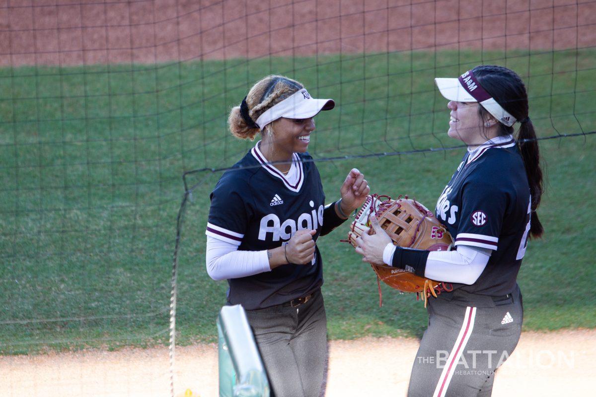 Sophomore infielder Rylen Wiggens (2) and sophomore infielder Trinity Cannon (26) talking by the dugout in Davis Diamond on Friday, Feb. 18, 2022.