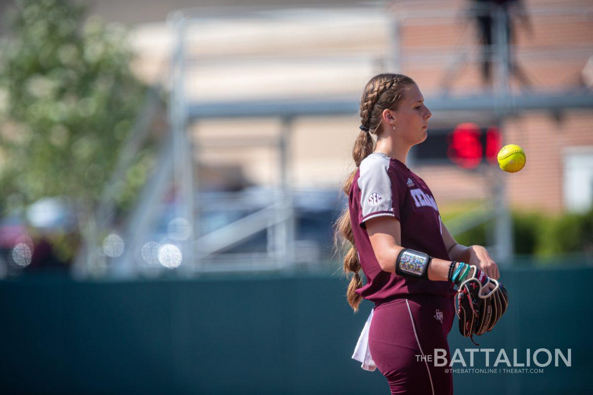 Freshman P/1B Emiley Kennedy (11) warmsup after being called into relieve sophomore P/OF Grace Uribe (8) at Davis Diamond on Saturday, May 7, 2022.