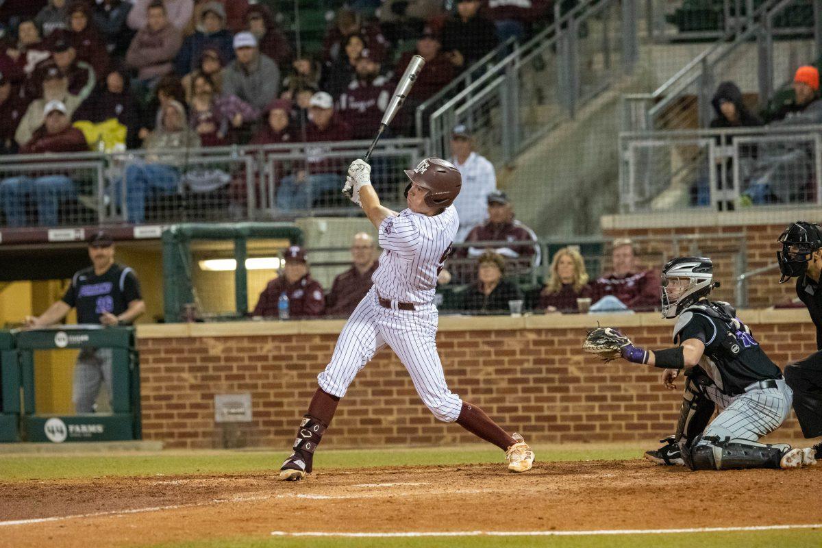 Junior 1B Jack Moss (9) swings at ball during Texas A&Ms game against Portland at Olsen Field on Friday, Feb. 24, 2023.