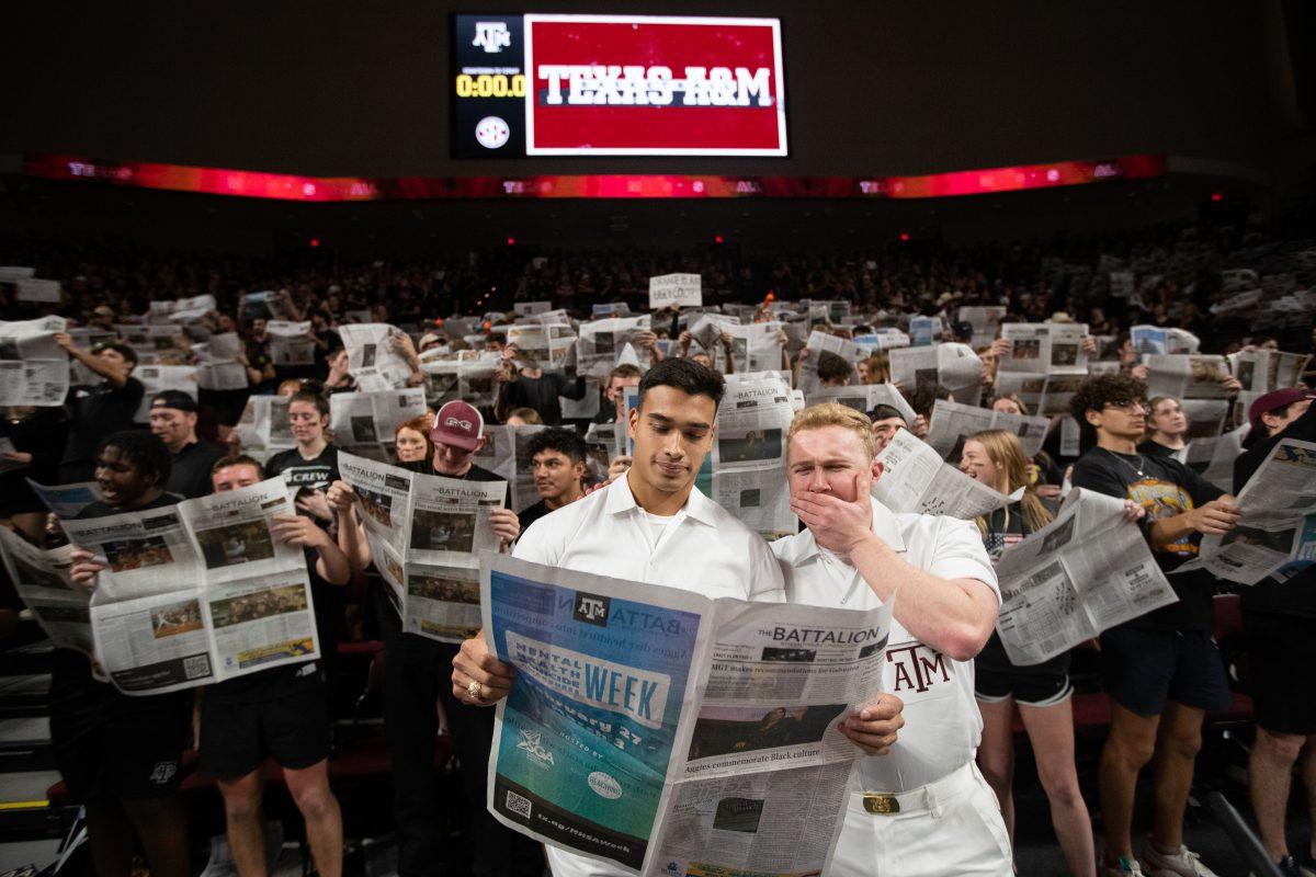 Senior Yell Leaders Zac Cross and Nathan Drain read the Battalion before A&Ms game against Tennessee in Reed Arena on Tuesday, Feb. 21, 2023.