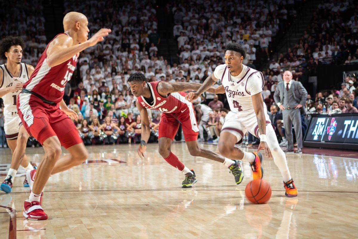 Sophomore G Wade Taylor IV (4) moves down the court during Texas A&Ms game against Arkansas at Reed Arena on Wednesday, Feb. 15, 2022.