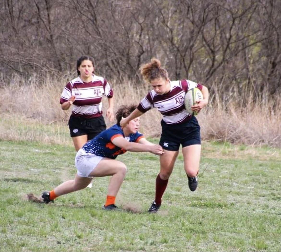 Suzanne Eubank and AnnMarie Johnston both of the A&amp;M Women&#8217;s Rugby White team, stiff-arms opponent in the Feb. 18 tournament against the University of Texas San Antonio.&#160;&#160;