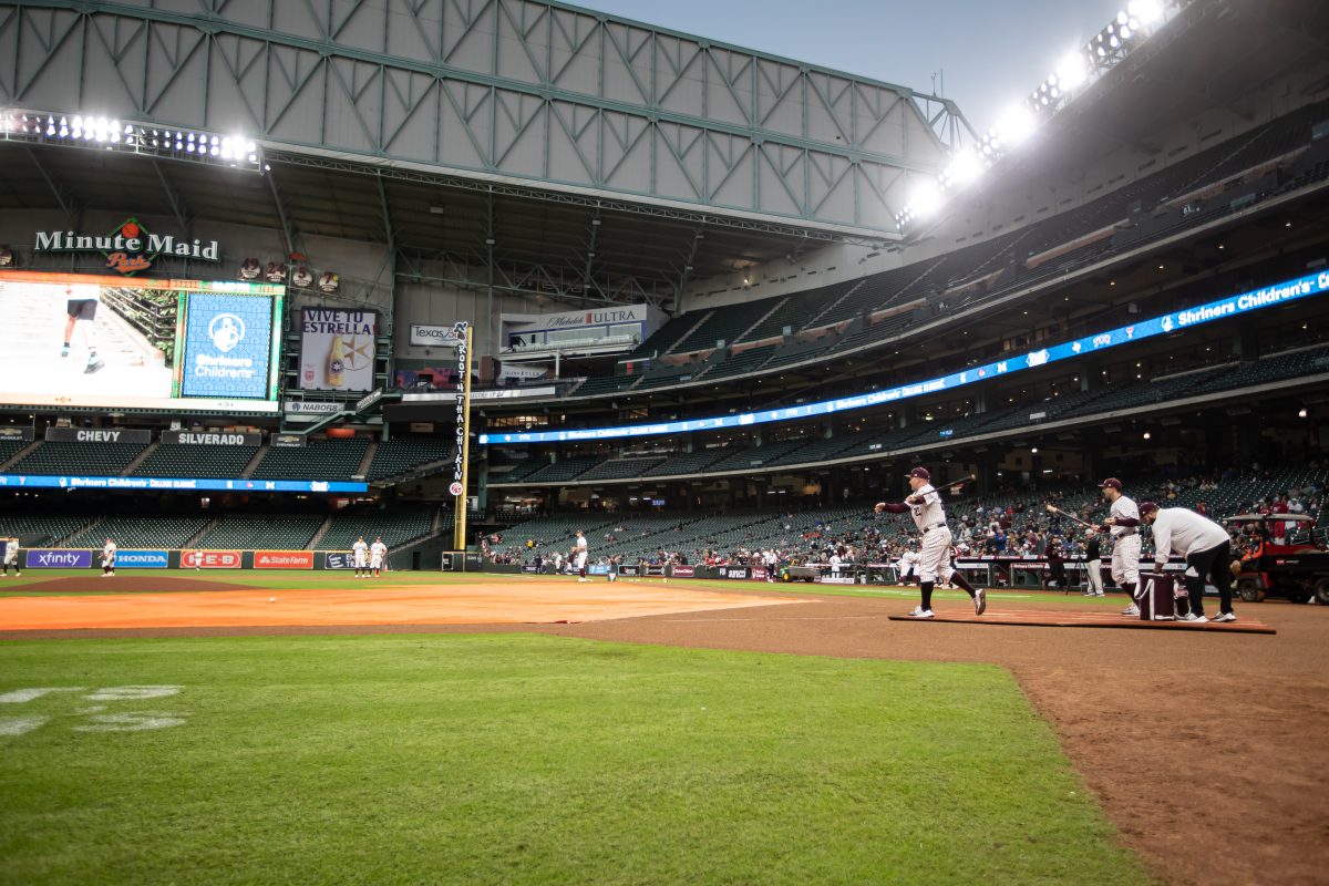 A&amp;M coach Jim Schlossnagle (22) hits ground balls during fielding practice prior to Texas A&amp;M's game against Louisville at Minute Maid Park in Houston, Texas, on Friday, March 3, 2023.