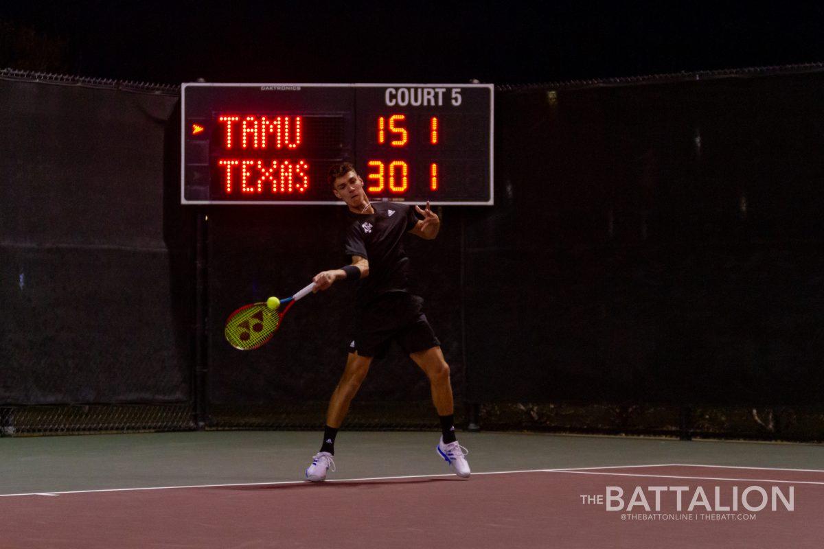 Freshman Giulio Perego returns a ball to Chih Chi Huang from the University of Texas at the Mitchell Tennis Center on Wednesday, Mar. 9, 2022.