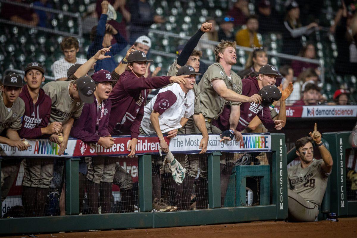 The Aggie dugout celebrates as junior C Hank Bard (48) runs home to score in the top of the 16th inning of Texas A&amp;M's game against Texas Tech at Minute Maid Park in Houston, Texas, on Monday, March 6, 2023.